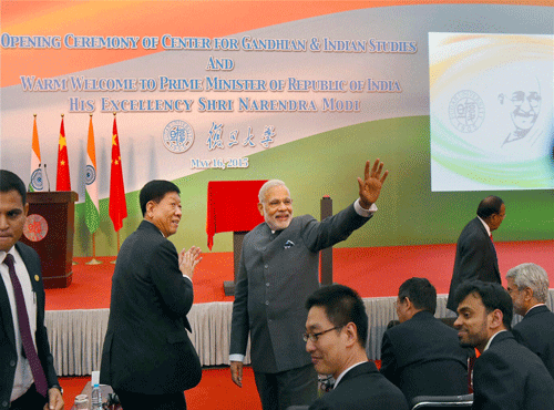 Prime Minister Narendra Modi waves during opening ceremony of Centre for Gandhian & Indian Studies at Fudan University in Shanghai on Saturday. PTI Photo