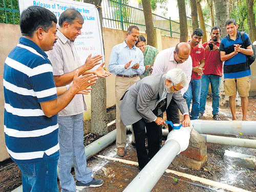 Vaman Acharya, Chairman, KSPCB, launches the experimental project that will treat sewage water fromthe apartments in JP Nagar 7th Phase, along with rain water, to be let into Puttenahalli lake. DH PHOTO