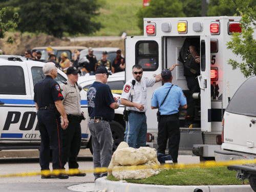 Emergency responders tend to a wounded person near a Twin Peaks restaurant. AP photo