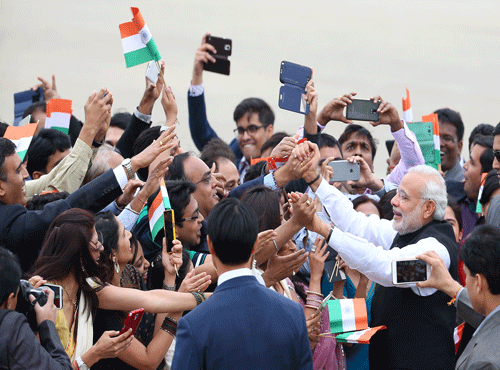 Indian Prime Minister Narendra Modi, right, is greeted by Indian residents upon his arrival at Seoul military airport in Seongnam, South Korea. AP photo