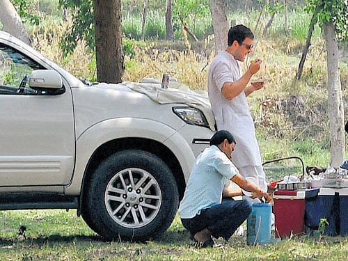Congress vice-president Rahul Gandhi takes a break for lunch in a village during hisAmethi visit onMonday. PTI