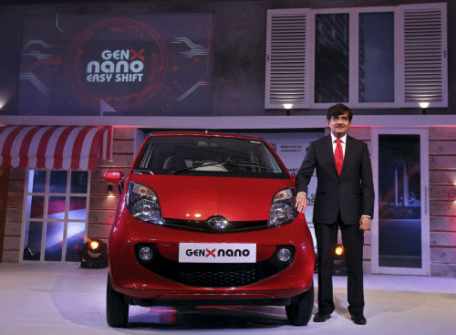 Pareek, President of Tata Motors PVBU poses with the company's new GenX Nano car during its launch in Mumbai. Reuters
