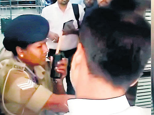 Picture shows a woman CISF personnel stops Union Minister Ram Kripal Yadav who is trying to entering Patna airport through the exit gate in Patna on Tuesday. PTI