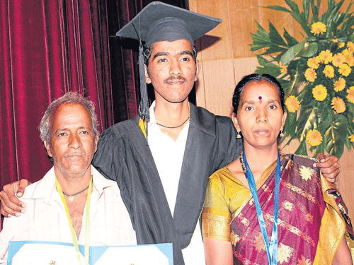Proud parents Yallappa Kolakar, who emerged the topper in BCom and bagged three gold medals, poses with his father Dattu and mother Yallavva, at the third annual convocation of Rani Channamma University in Belagavi on Wednesday. DH PHOTO