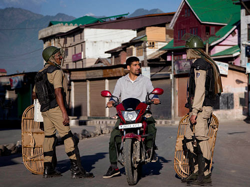 Indian paramilitary soldiers interrogate a Kashmiri motorcyclist at a temporary checkpoint in Srinagar, Indian controlled Kashmir, Thursday, May 21, 2015. Hundreds of government forces with automatic weapons patrolled the streets of Indian Kashmir's main city to stop a rally by separatists to mark the anniversaries of the assassinations of two Kashmiri leaders, Mirwaiz Mohammed Farooq and Abdul Gani Lone. AP Photo