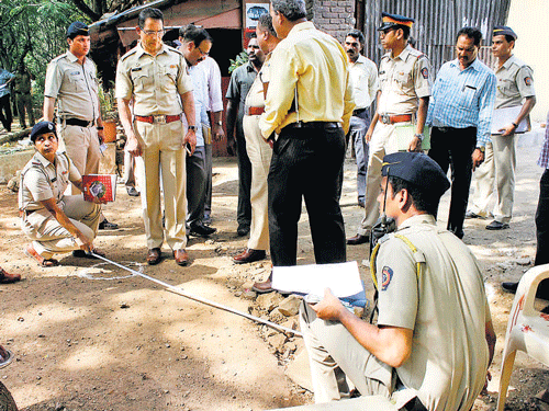Police officers investigate the spot after a shootout at the Filmcity at Goregaon East in Mumbai on Friday. PTI