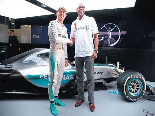 fuelling change: Former Olympic champ and Laureus Sport for Good Foundation Chairman Edwin Moses with F1 ace Nico Rosberg.  Clive Mason/Getty Images for Laureus