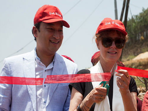 U.S. actress and Academy Award winner Susan Sarandon cuts a ribbon during the inauguration of a programme to build earthquake and wind resistant homes in Ramkot, Kathmandu May 24, 2015. REUTERS