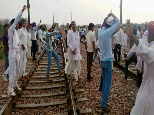 Gujjar community people agitating to demand reservation in government jobs and educational institutions for their community on Delhi-Mumbai railway track near Bayana village in Bharatpur district of Rajasthan on Thursday. PTI Photo