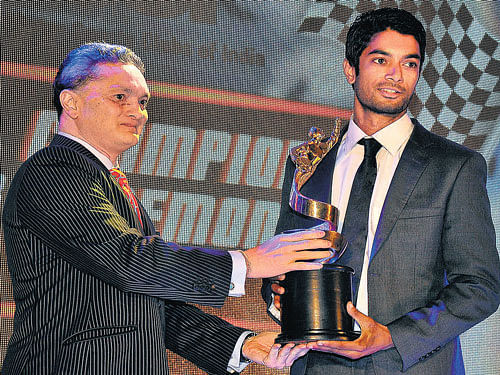 worthy: Gautam Singhania (left) presents Motorsport Man of the Year award to C S&#8200;Santosh on Monday. dh photo