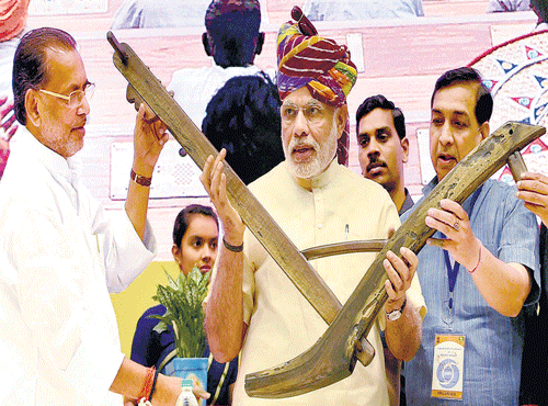 AGRARIANBROADCAST: PrimeMinister NarendraModi being presented amodel of plough during the launch of the DDKisan Channel in New Delhi. PTI