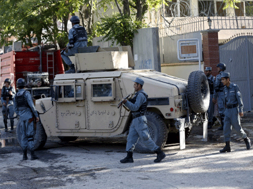 Afghan policemen stand guard near the site of an attack in Kabul, reuters photo