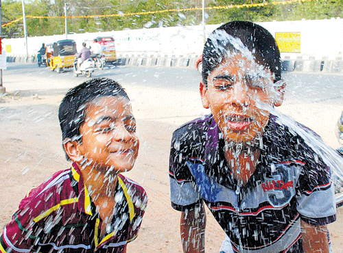 COOLINGAGENT: Boys splashwater on their faces to beat the heat inHyderabad onWednesday. PTI
