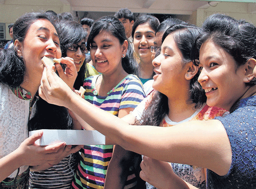 Students celebrate after announcement of 10th Class (CBSE) result at Venkat International School in Bengaluru on Thursday.