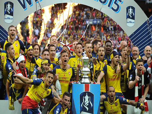 Arsenal players celebrate after winning the FA Cup final by beating Aston Villa 4-0 in the English FA Cup Final soccer match between Aston Villa and Arsenal at Wembley stadium, London. AP Photo
