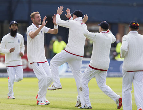 England's Stuart Broad, second left, celebrates with teammates after taking the wicket of New Zealand's Kane Williamson, caught by Jos Buttler for 6, on the third day of the second Test match between England and New Zealand