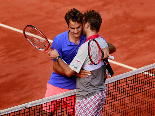 Switzerland's Stanislas Wawrinka with Roger Federer after defeating him in their quarter final match Action. Images via Reuters