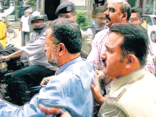 A TV&#8200;grab of bank representatives being taken in to   preventive custody,  infront of Vikram Hospital on Tuesday.