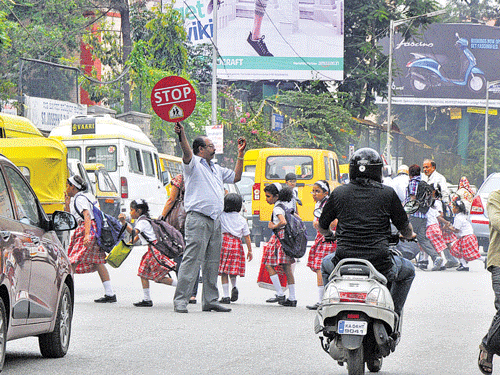 Dangerous Children struggle to cross Museum Road.