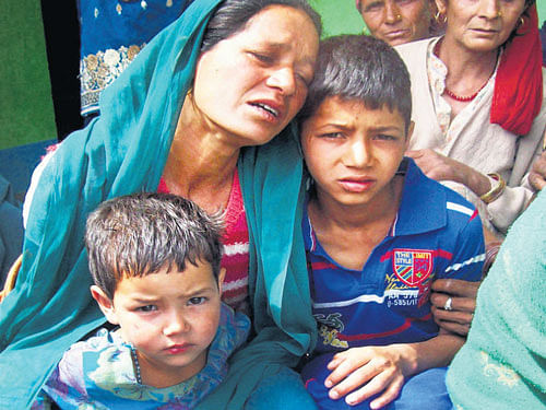 In Grief: The wife and children of Havildar Prakash Chand, who was killed in the Manipur ambush on Thursday, grieve at his native village Siun in the Mandi district ofHimachal Pradesh on Friday. PTI.