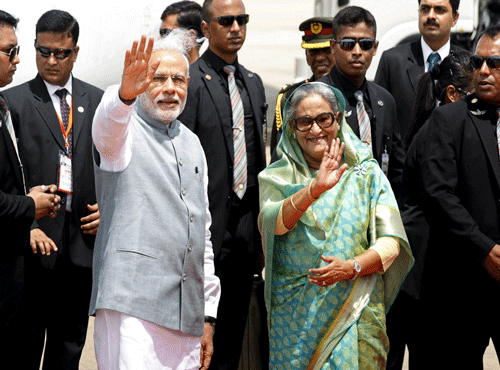 India's Prime Minister Modi waves with Bangladesh's Prime Minister Hasina at Shahjalal International Airport in Dhaka. Reuters photo