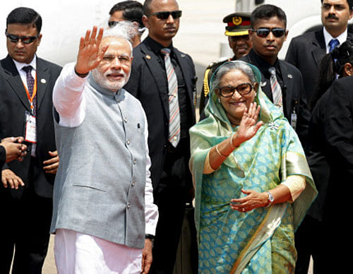 Narendra Modi waves with Bangladesh's Prime Minister Sheikh Hasina at Shahjalal International Airport in Dhaka. Reuters