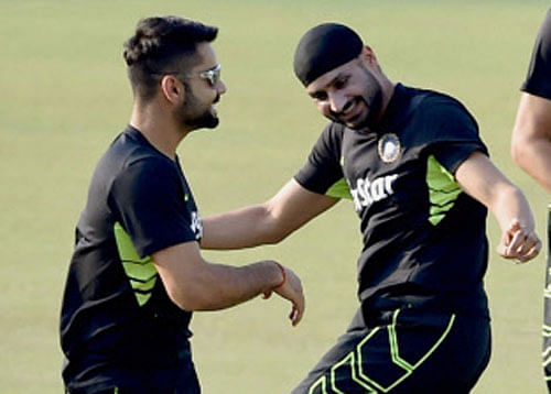 Indian Test Captain Virat Kohli and his teammate Harbhajan Singh during their fitness Test at Eden Garden in Kolkata on Saturday ahead of the Bangladesh tour. PTI