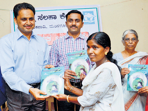 Deputy Commissioner A B Ibrahim hands over the copy of "Dhritee and Dhitulee - All about Pearl" to a student, at Prajna Counselling Centre in Mangaluru on Saturday. SP S D Sharanappa, Prajna Counselling Centre Director Prof Hilda Rayappan look on. DH PHOTO