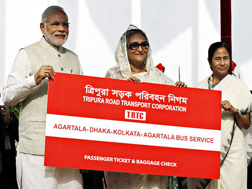 India's Prime Minister Narendra Modi (L), Bangladesh's Prime Minister Sheikh Hasina (C) and Chief Minister of West Bengal, Mamata Banerjee hold a replica ticket after the inauguration of Agartala-Dhaka-Kolkata bus service in Dhaka June 6, 2015. Reuters file photo