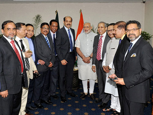 Prime Minister Narendra Modi meeting the presidents of leading Chambers of Commerce and Industry in Bangladesh, in Dhaka on Sunday. PTI Photo