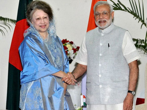 Prime Minister Narendra Modi shakes hands with the former Prime Minister of Bangladesh, Begum Khaleda Zia at a meeting in Dhaka, Bangladesh on Sunday. PTI Photo