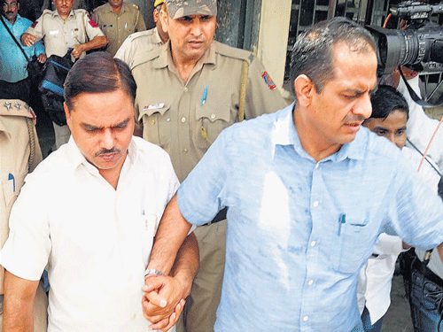 Police take former Delhi law minister Jitendra Singh Tomar to RMLAwadh University in Faizabad onWednesday for further investigation in fake degree case. PTI