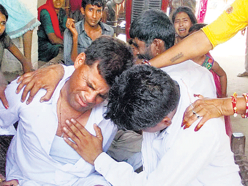 People grieve the death of a relative in the bus tragedy in Tonk district on Friday. PTI