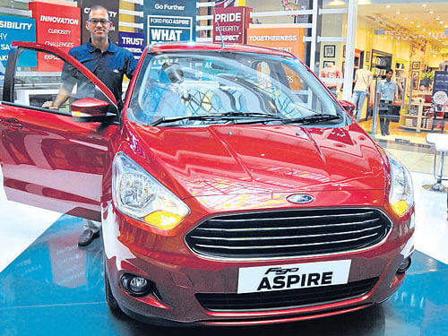 Ford India Marketing Vice President Raj Sarkar poses with the Ford Figo Aspire which was showcased in Bengaluru  on Saturday. DH Photo by B K Janardhan