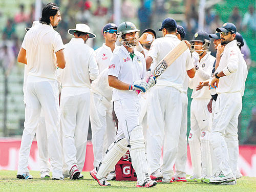early departure: Indian players celebrate after dismissing Bangladesh opener Tamim Iqbal on Saturday. AP