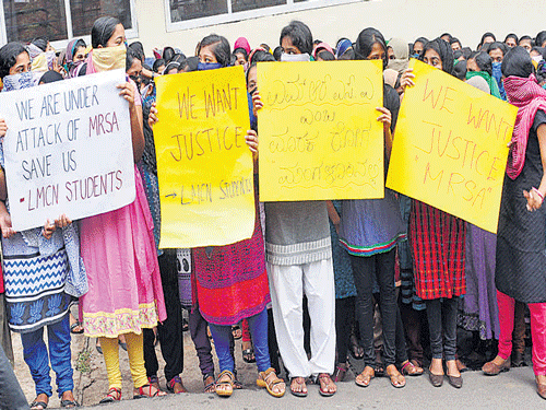 Students protest in front of Laxmi Memorial College of Nursing on Balmatta Road in Mangaluru on Saturday. DH Photo