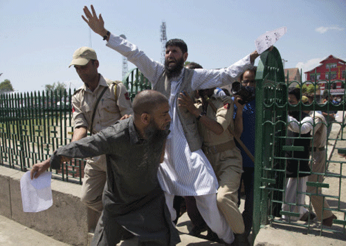 Activists of hardline faction of Kashmir's main separatist alliance All Parties Hurriyat Conference (APHC), shout slogans as police detain them during a protest in Srinagar. AP photo