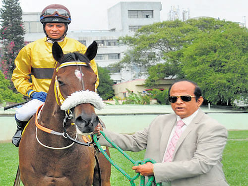 PROUD moment Trainer S Ganapathy leads in Eternal Flame (with jockey A Sandesh astride), which won the Fillies  Championship Stakes on Sunday. DH PHOTO.