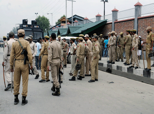 Heavy Police personnel deployed around Civil Secretariat in Srinagar on Monday after the killing of a civilian by unidentified gunman in Sopore. PTI Photo