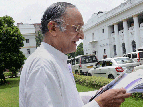 West Bengal Finanace & Industry Minister Amit Mitra goes through the 'New Anti Chit Fund Bill' before placing it at the floor of State Assembly in Kolkata on Tuesday. PTI Photo