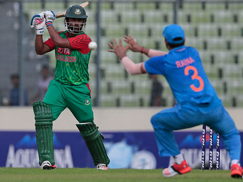 Bangladesh's Tamim Iqbal, left, plays a shot, as India's Suresh Raina attempts to field during their first one-day international cricket match in Dhaka, Bangladesh, Thursday, June 18, 2015. AP Photo