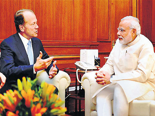 Prime Minister Narendra Modi (right) listens to Cisco  Chairman John Chambers as they talk during a meeting in New Delhi on Thursday. PTI