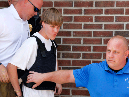 Police lead suspected shooter Dylann Roof, 21, into the courthouse in Shelby, North Carolina, June 18, 2015. Roof, a 21-year-old with a criminal record, is accused of killing nine people at a Bible-study meeting in a historic African-American church in Charleston, South Carolina, in an attack U.S. officials are investigating as a hate crime. REUTERS Photo