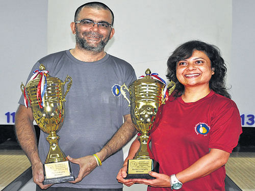 all smiles: Champions Vijay Punjabi (men's) and Judy Allan  (women's) pose with their spoils on Friday.