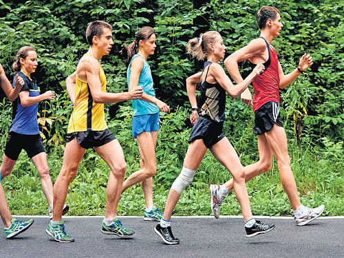 under a cloud: Russian race walkers, including Olga Kaniskina (second from right), who was barred in January 2015 for doping violations, and Elena Lashmanova (third from right), also caught doping, train in Saransk, Russia in August, 2013. NYT