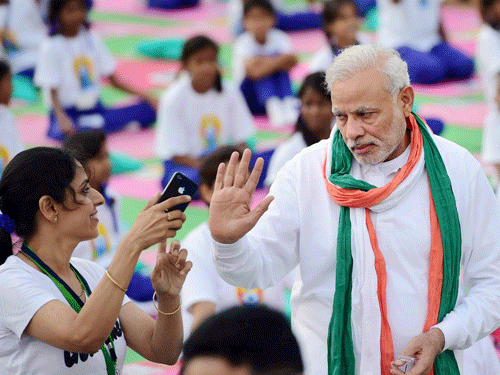 Prime Minister Narendra Modi participates in a mass yoga session to mark the International Day of Yoga 2015 at Rajpath in New Delhi on Sunday. PTI Photo