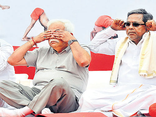 SEE, HEAR&#8200;NO&#8200;ILL: (From right to left) Chief Minister Siddramaiah, Higher Education Minister R V Deshpande, Home Minister  K J George and Medical Education Minister Sharanprakash Patil perform yoga at the International Yoga Day programme at Kanteerava stadium in the City on Sunday. dh Photo