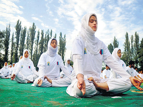 Healthy lifestyle:  Kashmiri school students  perform yoga on the occasion of the first International Day of Yoga in Anantnag district on Sunday. pti