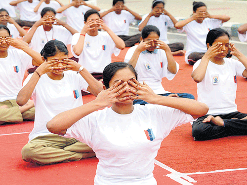 NCC cadets perform Yoga at Vidhana Soudha premises in Bengaluru on Sunday. DH photo