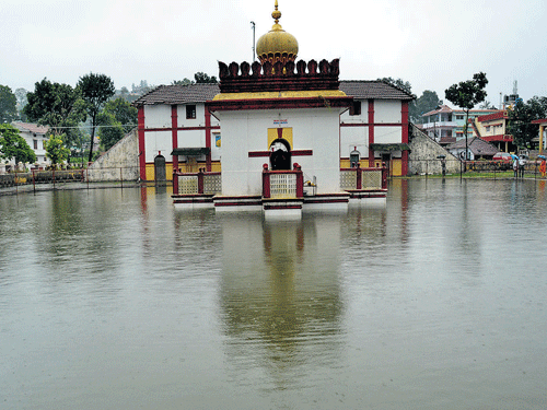 A pond in front of Omkareshwara temple is filled in Madikeri. DH photo